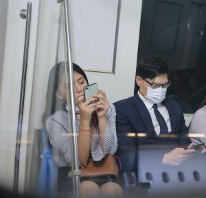 People wear protective face mask during stay on commercial train.