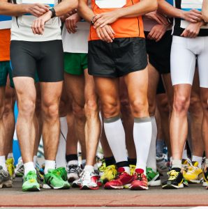 Legs of athletes before marathon start.