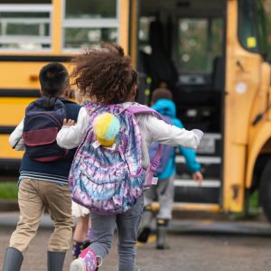 Children running to catch a schoolbus