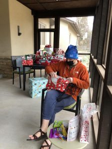 Theo Cohen opens gifts at a safe distance from the rest of the family on Christmas.